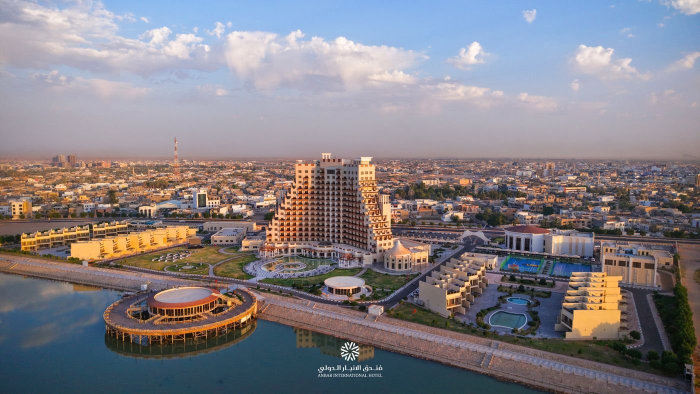 منظر جوي لفندق الأنبار الدولي وحدائقه وشاليهاته على ضفة النهر عند الغروب